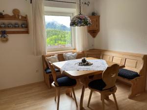 a dining room with a table and chairs and a window at Panoramic Alpine Residence in Eisenerz