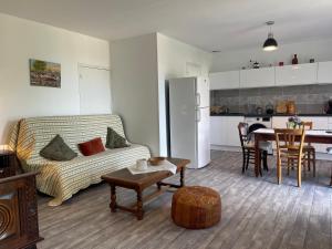 a living room with a couch and a table at Gite de la vallée in Rochechouart