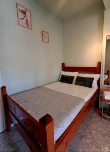 a bedroom with a wooden bed in a room at Helen's studio in Leptokarya +2 photos