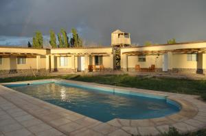 a house with a swimming pool in front of it at El Mirador A Los Andes in Barreal