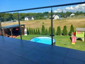 a view of a swimming pool from the balcony of a house at U Rybaka in Mielenko