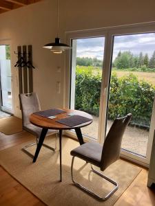 a dining room with a table and chairs and a window at Haus zum See in Uhldingen-Mühlhofen
