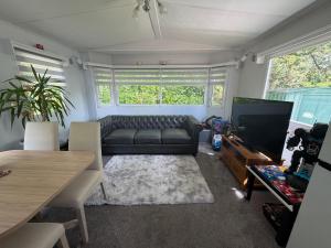 a living room with a couch and a flat screen tv at Lisa retreat in Preston