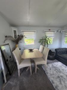 a living room with a table and chairs and a couch at Lisa retreat in Preston