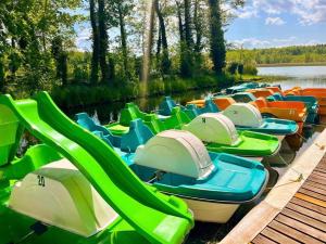 a row of boats lined up in the water at Całoroczny Domek Chill in Sława