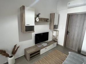 a living room with a flat screen tv on a wall at Molys House in Igoumenitsa