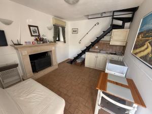a living room with a staircase and a fireplace at La Meridiana in Faleria