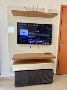 a flat screen tv hanging on a wall at 05-Conforto e Modernidade com piscina e garagem in São Leopoldo