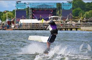 a person is water skiing in the water at Całoroczny Domek Chill in Sława