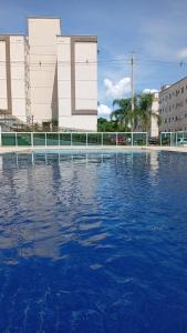 a large pool of water in front of a building at 05-Conforto e Modernidade com piscina e garagem in São Leopoldo