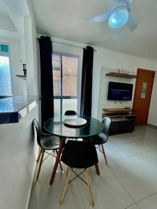 a dining room with a glass table and chairs at 05-Conforto e Modernidade com piscina e garagem in São Leopoldo