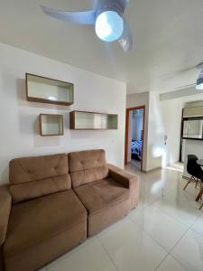 a living room with a brown couch in a room at 05-Conforto e Modernidade com piscina e garagem in São Leopoldo