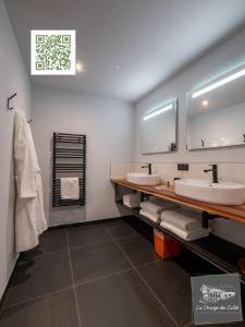 a bathroom with two sinks and a mirror at La Grange des Eulets in Bourg-Saint-Maurice +45 photos