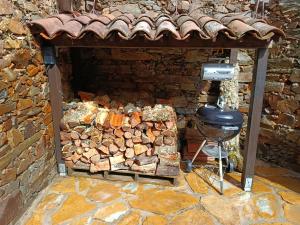 a pile of fire wood in a brick oven at El Silencio in Mesegal