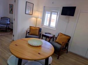 a living room with a wooden table and chairs at Entre Muralhas - Cozy Apartment Elvas I in Elvas