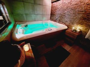 a bathroom with a blue tub in a room at La Suite in La Calamine