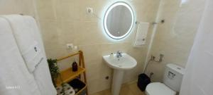 a bathroom with a sink and a mirror and a toilet at Sunrise house in Ribeira Grande +12 photos