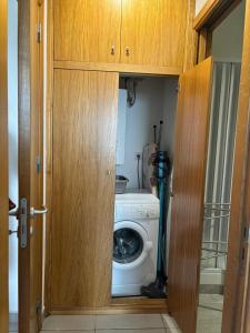 a washer and dryer in a kitchen with a door at Taormina Belu Beach Apartment in Letojanni