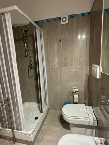 a bathroom with a shower and a toilet and a sink at Taormina Belu Beach Apartment in Letojanni +14 photos
