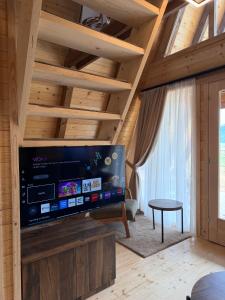 a living room with a large flat screen tv at Etno Selo Dolina Pive in Plužine