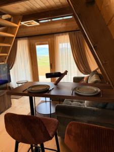 a living room with a table and a couch at Etno Selo Dolina Pive in Plužine +9 photos