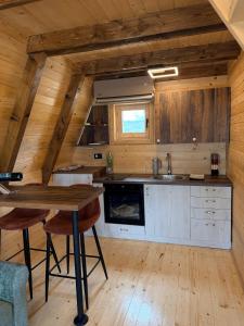 a kitchen with wooden walls and a wooden table at Etno Selo Dolina Pive in Plužine
