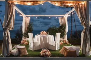 a dinner table under a tent with a view of the ocean at La Villa Del Re - Adults Only - Small Luxury Hotels of the World in Castiadas +65 photos