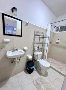 a bathroom with a toilet and a sink and a shower at Private apartment near the esplanade - KB2 in Campeche +23 photos