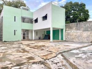 an old white house with a large yard at Private apartment near the esplanade - KB2 in Campeche