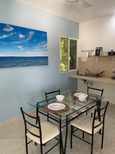 a dining room with a glass table and chairs at Private apartment near the esplanade - KB2 in Campeche