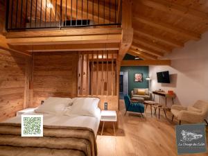 a bedroom with a bed and a living room at La Grange des Eulets in Bourg-Saint-Maurice