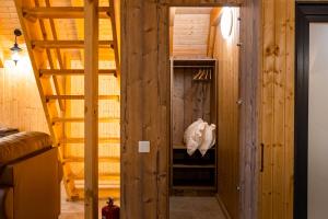 a room with wooden walls and a hallway with a door at A Frame by Tinutul Marului in Voineşti