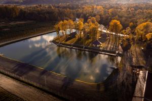 an aerial view of a river with trees in the background at A Frame by Tinutul Marului in Voineşti