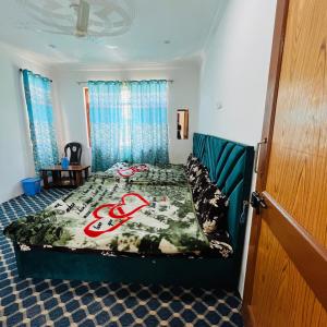 a bedroom with a bed in a room with blue curtains at Supreme Lake in Srinagar