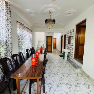 a dining room with a wooden table and chairs at Supreme Lake in Srinagar