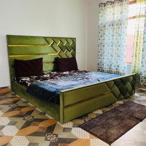 a bedroom with a large green bed in a room at Supreme Lake in Srinagar