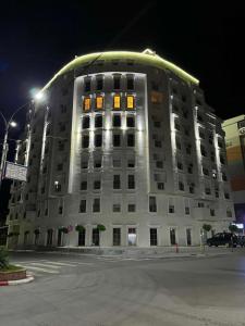 a large white building at night with lights on at Zen Central Gevgelija in Gevgelija