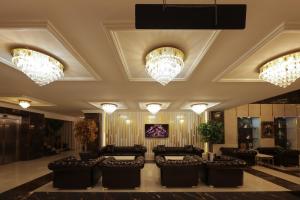a lobby with black chairs and chandeliers at Vera Vista Hotel in Ipekyolu