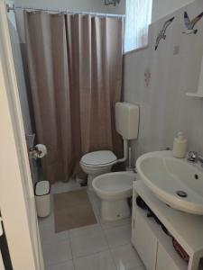 a bathroom with a toilet and a sink at Conchiglia in Lipari