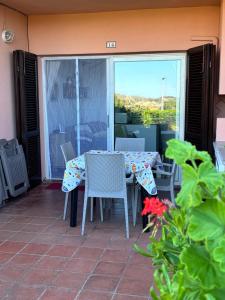 a table and chairs on a patio with a view at Casetta Spinnaker in Palau