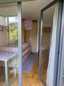 a dining room with a table and a mirror at Bajo con jardín in Miengo