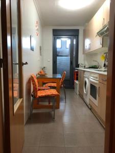 a kitchen with a table and chairs in a kitchen at Bajo con jardín in Miengo