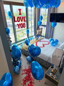 a room with blue balloons and a bed with a i love you sign at Mullet Bay Suites - Your Luxury Stay Awaits in Cupecoy +125 photos