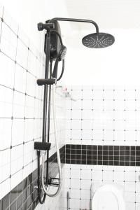 a shower in a bathroom with a toilet at Progressive Success Residency in Juja +52 photos