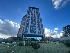 a tall building with flowers in front of it at View Soft House Apto 1007 in Lauro de Freitas