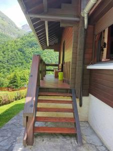 a porch of a house with a wooden staircase at Chalet Borce 64 in Borce