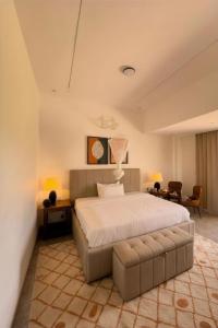a large bedroom with a bed and a couch at Plenty Residence by Splendid Hotel, Retreat & Group Stay Near Kigali in Runda +38 photos