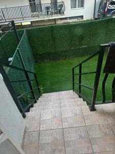 a stairway leading to a green wall with a building at Otopeni Maramures in Otopeni +3 photos