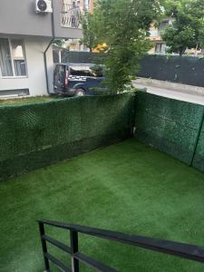 a garden with a bench in front of a fence at Otopeni Maramures in Otopeni