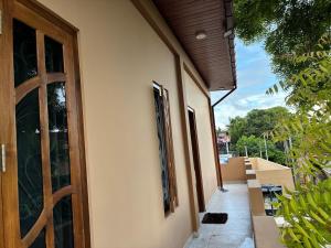 a door to a house with a balcony with at Velu House - 2-Room Apartment in Jaffna
